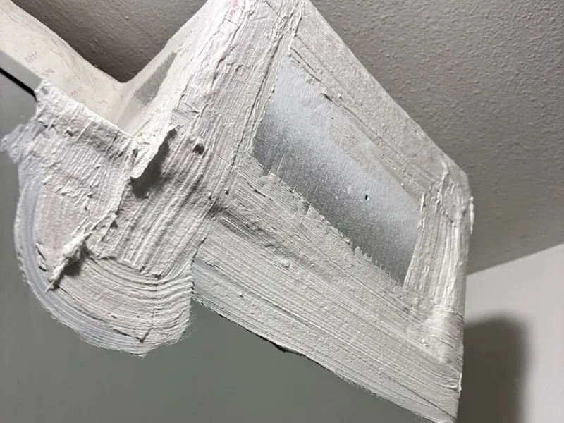 Duct connection on top of an air handler, fully sealed with white mastic